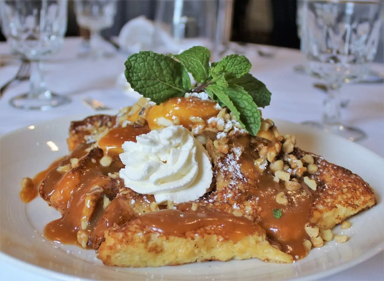 Bananas foster French toast with whipped cream and mint